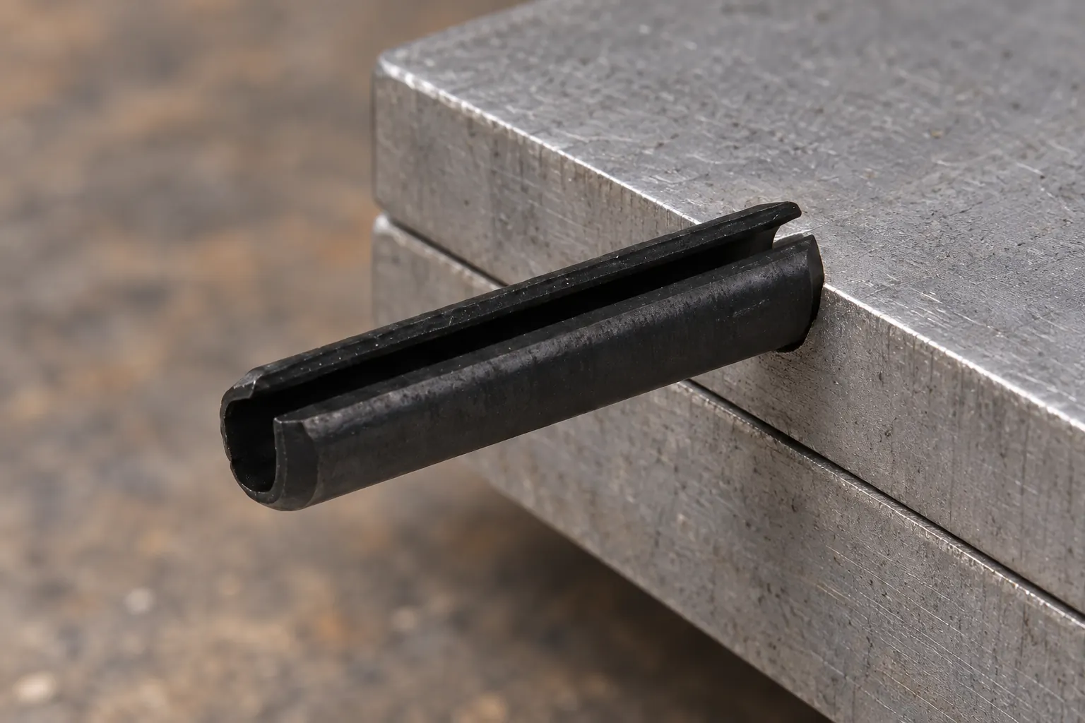 Technician installing a resilient pin with an aligned punch and fixture